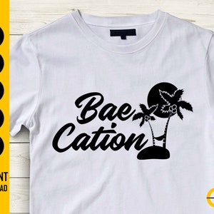 May include: White t-shirt with the words "Bae Cation" in a black script font, accompanied by a black silhouette of palm trees and a sun. The left side of the shirt has SVG, DXF, PNG, EPS, and AI icons.