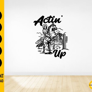 May include: Black and white illustration of a cowgirl riding a rearing horse, with the words "Actin' Up" in a stylized font. The design includes desert landscape elements and is likely a digital graphic.