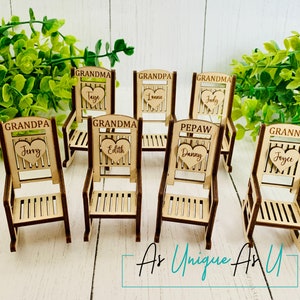 May include: Set of eight miniature wooden rocking chairs with personalized hearts. Each chair is labeled with a name and title, such as "Grandma", "Grandpa", "Pepaw", and "Granny".