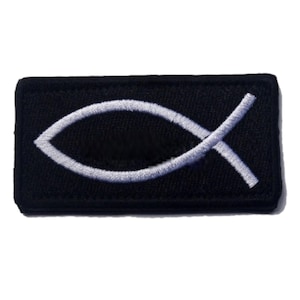 May include: A black fabric patch with a white embroidered Ichthys symbol, also known as the Jesus fish.