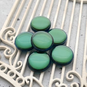 May include: A set of three ceramic mugs with a speckled, matte finish. The mugs are in shades of cream, light brown, and dark brown. Each mug has a simple, minimalist design, perfect for coffee or tea.