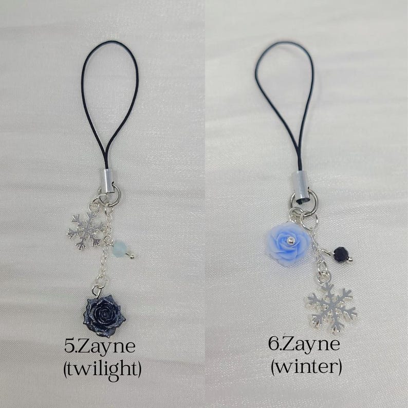May include: Two phone charms with black loops and silver-tone chains. The first charm, labeled 5.Zayne (twilight), features a silver snowflake, a light blue bead, and a dark blue rose. The second, 6.Zayne (winter), has a light blue rose and a silver snowflake.