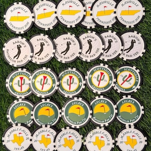 May include: A collection of twenty-five round poker chips arranged in five rows. The chips feature various designs including Nashville Tennessee 2026, Aaron's Bachelor Par-Tee, Scottsdale Arizona 2026, Lucas's Bachelor Par-Tee, and Marble Falls Texas 26.