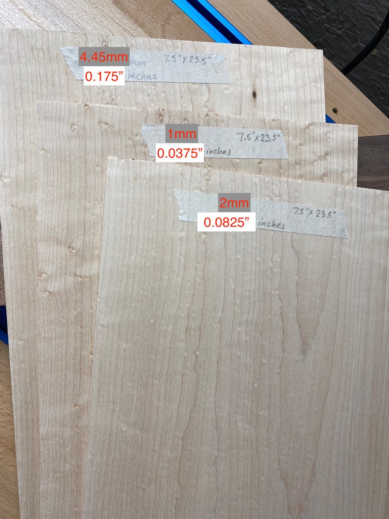 May include: Three pieces of wood veneer, each with a different thickness. The top piece is 0.175 inches thick, the middle piece is 0.0375 inches thick, and the bottom piece is 0.0825 inches thick. Each piece is 7.5 inches by 23.5 inches.