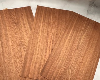 May include: Three sheets of wood veneer with a brown wood grain pattern.