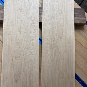 May include: Two light brown wood panels with a unique grain pattern. The panels are approximately 12 inches wide and 36 inches long.