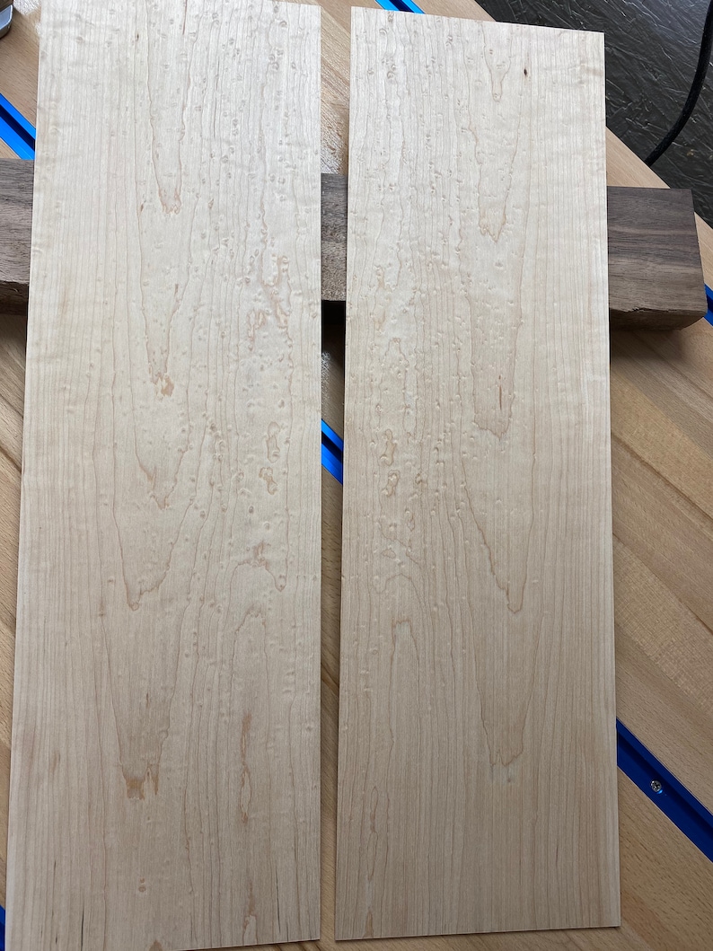 May include: Two light brown wood panels with a unique grain pattern. The panels are approximately 12 inches wide and 36 inches long.