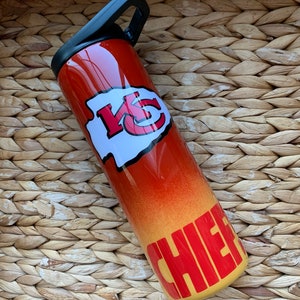 May include: A red and yellow stainless steel water bottle with a Kansas City Chiefs logo and the word "Chiefs" in yellow letters.