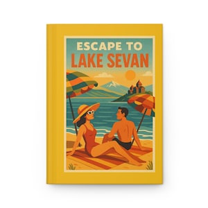 May include: A yellow journal with the text "ESCAPE TO LAKE SEVAN" and a vintage travel poster design. The illustration depicts a couple relaxing on a beach with umbrellas, mountains, and a lake in the background. The journal is a hardcover.