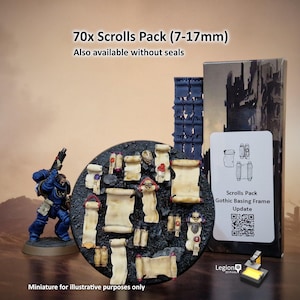May include: A 70x Scrolls Pack (7-17mm) featuring miniature parchment scrolls with wax seals, displayed on a circular textured base. Includes a blue armored miniature figure, a tall dark structure, and a box labeled Scrolls Pack Gothic Basing Frame Update with a QR code.