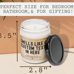 May include: A white candle in a glass jar with a black lid. The candle is 3.5 inches tall and 2.8 inches wide. The label on the jar reads "Smells like a custom text in here".