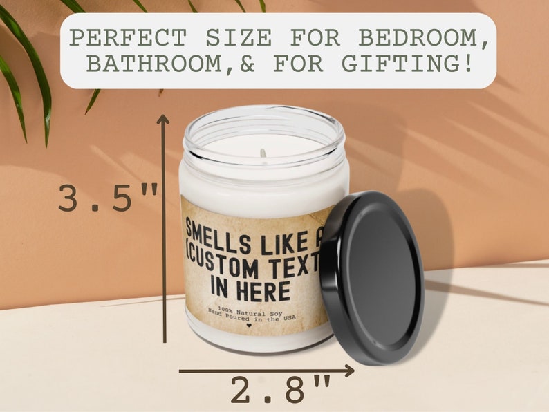 May include: A white candle in a glass jar with a black lid. The candle is 3.5 inches tall and 2.8 inches wide. The label on the jar reads "Smells like a custom text in here".