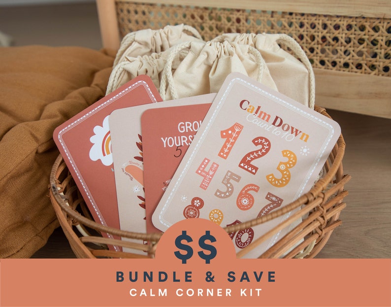 K&ouml;nnte beinhalten: Ein Satz bunter Karten mit Illustrationen und Text, darunter "Calm Down Count to 10" und "Grow Yours 5". Die Karten befinden sich in einem Weidenkorb mit wei&szlig;en Kordelbeuteln.