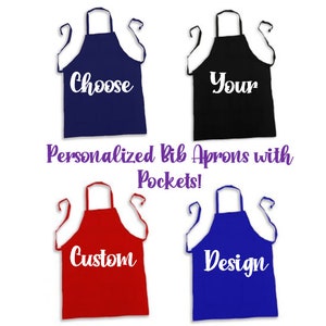 May include: Four personalized bib aprons with pockets. The aprons are navy blue, black, red, and blue. The text on the aprons reads "Choose", "Your", "Custom", and "Design".