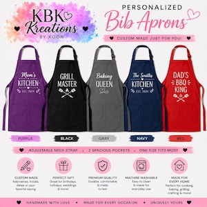 May include: Five bib aprons in purple, black, gray, navy, and red, each featuring white text and graphics. The aprons include adjustable neck straps and two front pockets. Text includes 'Mom's Kitchen', 'Grill Master', 'Baking Queen', 'The Smiths Kitchen', and 'Dad's BBQ King'.