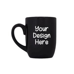 May include: A black ceramic mug with a heart-shaped handle. The mug has the text "Your Design Here" printed on the front in white.