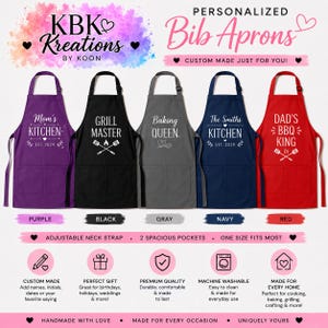 May include: Five bib aprons in purple, black, gray, navy, and red, each featuring white text and graphics. The aprons include adjustable neck straps and two front pockets. Text includes 'Mom's Kitchen', 'Grill Master', 'Baking Queen', 'The Smiths Kitchen', and 'Dad's BBQ King'.