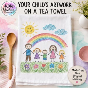 May include: A white tea towel featuring a colorful child's drawing of a family holding hands under a rainbow, sun, and clouds, with green grass and flowers at the bottom. The text reads: YOUR CHILD'S ARTWORK ON A TEA TOWEL and Made From Their Original Drawing.