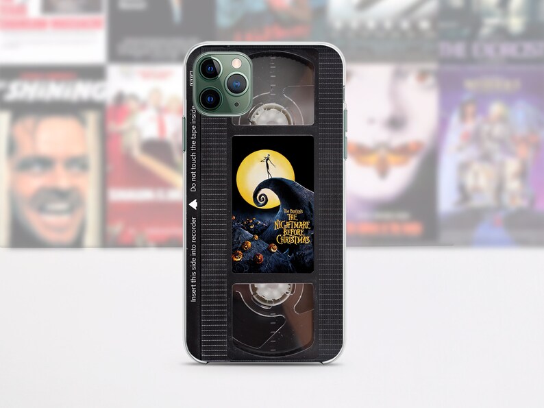 Op de afbeelding: Zwart-witte telefoonhoes met een vintage VHS-tape ontwerp met de film "The Nightmare Before Christmas". De hoes heeft een zwart-witte afbeelding van Jack Skellington aan de voorkant.