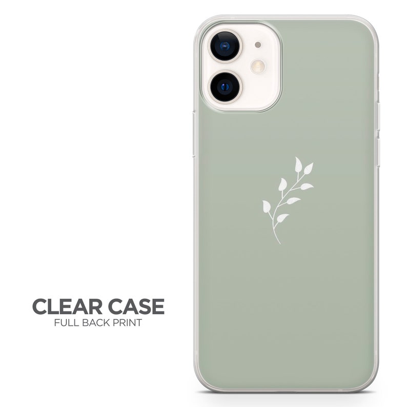 May include: A clear phone case with a sage green back and a white floral design. The case is designed for an iPhone with a camera bump.