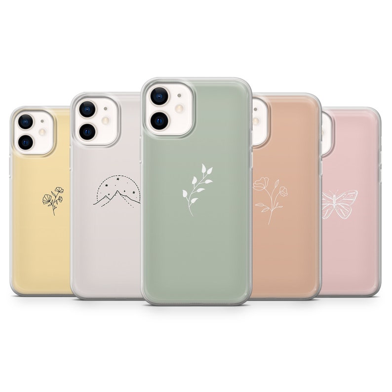 May include: Five clear phone cases with different minimalist designs. The cases are in various colors, including yellow, pink, green, beige, and peach. Each case features a simple line drawing of a flower, mountain, branch, butterfly, or flower.