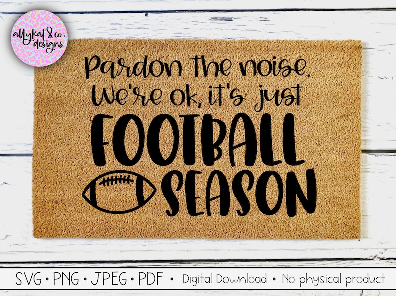 May include: A brown doormat with the text "Pardon the noise. We're ok, it's just FOOTBALL SEASON" in black lettering. A black and white football graphic is to the left of the word "SEASON".