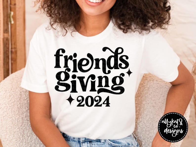 May include: White t-shirt with black text that reads "Friendsgiving 2024".
