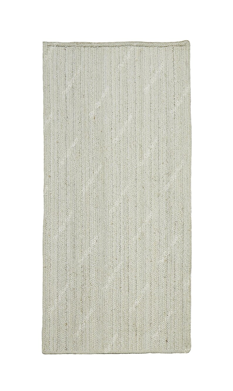 May include: A light gray woven rug with a subtle texture. The rug has a rectangular shape and a simple design.