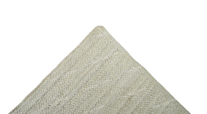May include: A close-up of a light gray textured fabric with a subtle pattern. The fabric is folded into a triangle shape.