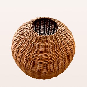 May include: A round, brown wicker basket with a wide opening at the top.