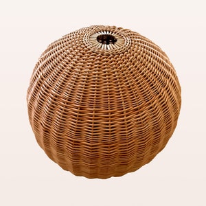 May include: A round, brown wicker lampshade with a woven pattern.