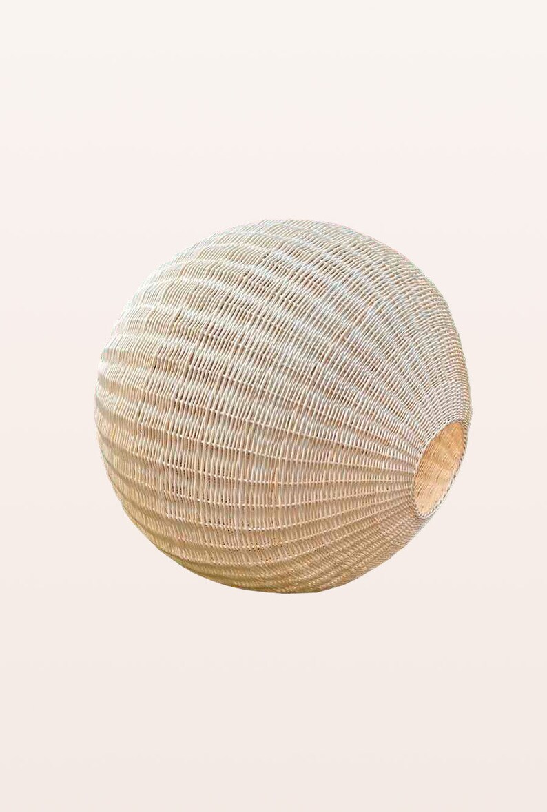 May include: A large, round, woven wicker pendant light fixture with a natural beige color.