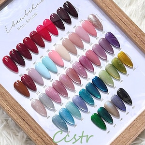 May include: A nail polish color chart with 50 different colors, numbered 001 to 050. The colors range from red, pink, blue, green, and gold. The chart is labeled "Cheabilus Nail Salon" and "Cestr".