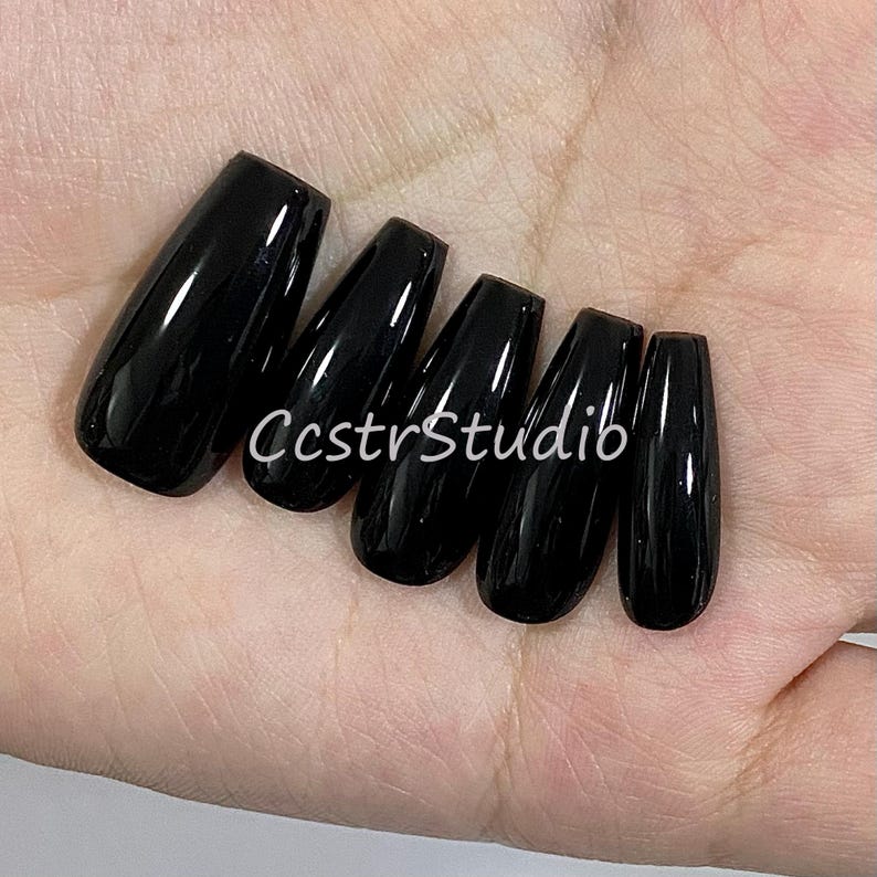 May include: Five black coffin-shaped false nails with a glossy finish.
