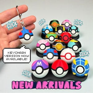 May include: A collection of colorful, round novelty items, resembling cartoon character balls, with a variety of designs and colors. One is attached to a keychain. Text reads "KEYCHAIN VERSION NOW AVAILABLE!" and "NEW ARRIVALS".