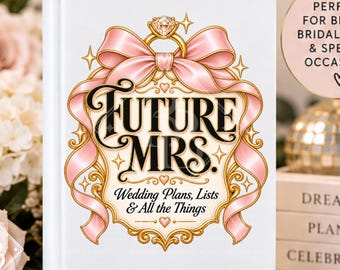 May include: A white hardcover journal featuring a central graphic of a diamond ring atop a pink ribbon bow, with the black text "FUTURE MRS. Wedding Plans, Lists & All the Things" enclosed in a gold ornate frame, set against a floral background.