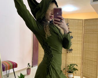 May include: A green hooded dress with a lace-up detail on the side. The dress is short and has long sleeves.