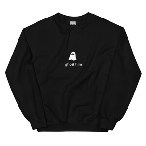 May include: Black crew neck sweatshirt with a white ghost graphic and the text "ghost him". The sweatshirt is made of a soft material.