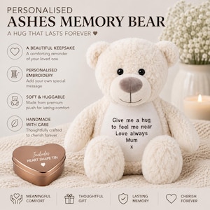 May include: A cream-colored plush teddy bear with a white patch on its chest embroidered with the text 'Give me a hug to feel me near Love always Mum x'. Beside the bear sits a metallic heart-shaped tin labeled 'Includes HEART SHAPE TIN'.
