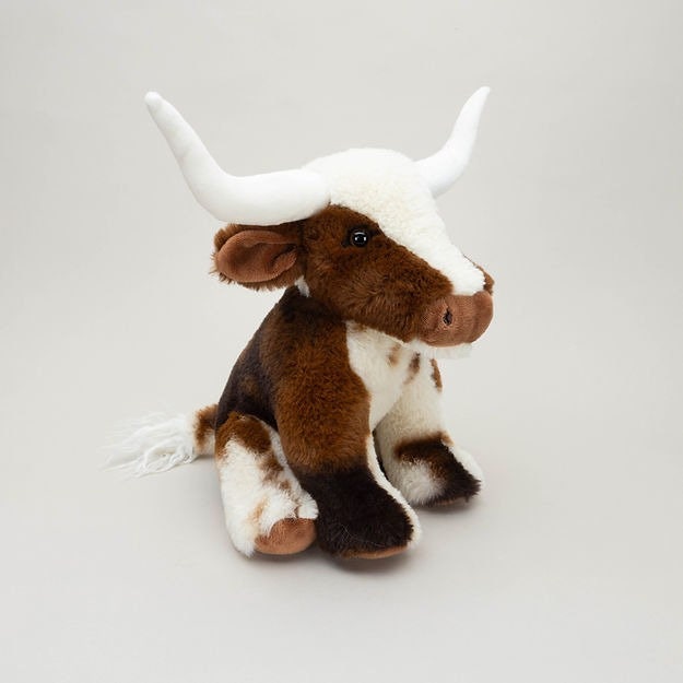Giocattoli di peluche di mucca delle Highland sdraiata pelosa