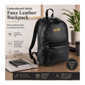 Pode incluir: Uma mochila de couro sintético preta com as iniciais AW bordadas em dourado. A mochila possui uma alça superior, alças ajustáveis, um compartimento principal com zíper e um bolso frontal com zíper. Texto na imagem: Embroidered Initial Faux Leather Backpack, Dimensions: 47 x 31 x 16 cm.