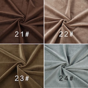 May include: A grid of four fabric swatches with a soft, velvet-like texture, each gathered in the center. The colors are dark brown labeled 21#, light taupe labeled 22#, olive brown labeled 23#, and muted light blue-gray labeled 24#.