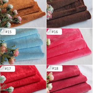 May include: A close-up of ten fabric swatches in various colors, including brown, light blue, pink, and red. Each swatch is folded in thirds and labeled with a number from 13 to 18.