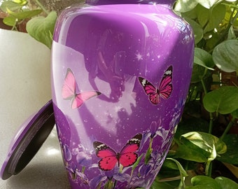 May include: Purple cremation urn with a silver lid and a design of pink butterflies and flowers.