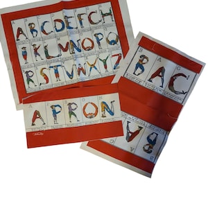 May include: Three red fabric squares with white borders, each featuring a different section of the alphabet. The letters are formed by people in various poses. The text on the squares reads: "ABCDEFCH", "KLMNOPQ", "RSTVWXYZ", "BAG", "BAC", "APRON".