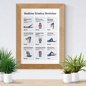 May include: A framed print titled "Bedtime Sciatica Stretches" with illustrations of various exercises. The print is in a light brown wooden frame and includes instructions for each stretch. The image is displayed on a light-colored surface with potted plants.