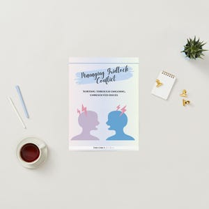 May include: A book titled "Managing Gridlock Conflict" with illustrations of two silhouetted heads with lightning bolts. The book is on a white surface with a cup of coffee, pens, a notepad, and decorative gold paper clips.