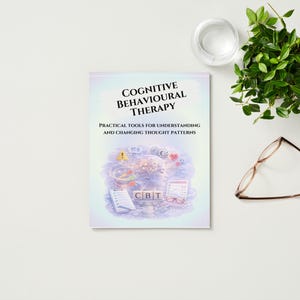 May include: A book titled "Cognitive Behavioural Therapy" with the subtitle "Practical Tools for Understanding and Changing Thought Patterns." The book is on a white surface, with glasses, a plant, and a glass of water.