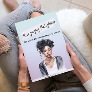 May include: A person is holding a book titled "Recognizing Gaslighting: Breaking Free From Manipulation" with a watercolour illustration of a woman with dark hair on the cover.