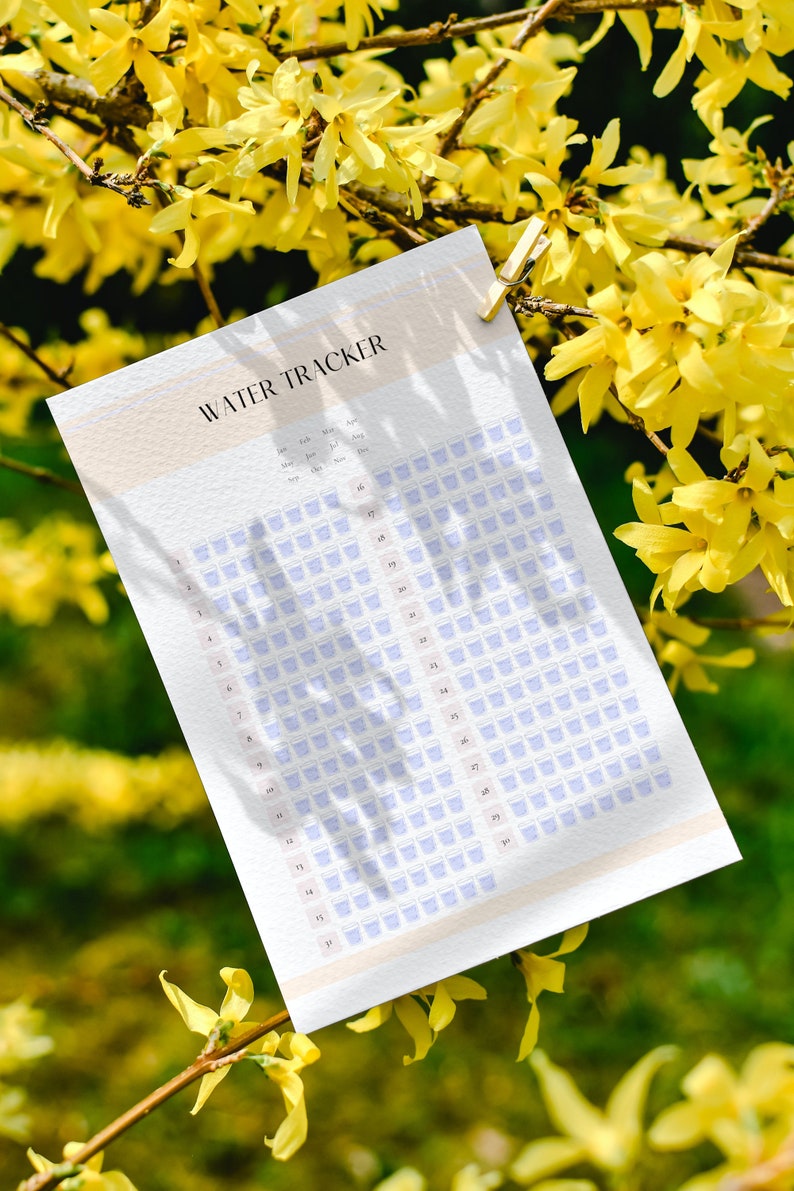 May include: A printable water tracker with a light peach background and a grid of blue water glasses. The tracker is labeled "WATER TRACKER" and includes months of the year from January to December.